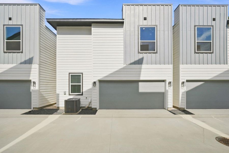 Private internal drive providing convenient access to the rear-entry attached garages, keeping vehicle access within the gated community. Private internal drive providing convenient access to the rear-entry attached garages, keeping vehicle access within the gated community.