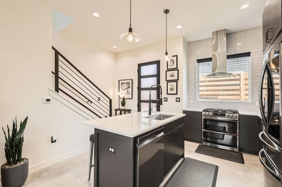 Chef-inspired kitchen featuring a large center island with breakfast bar, perfect for casual dining or meal prep.