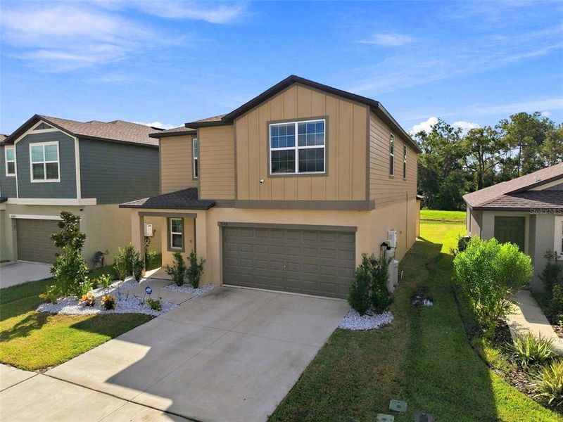 Front exterior of a new home in Two Rivers, Zephyrhills, FL, highlighting curb appeal (Image 1). Front exterior of a new home in Two Rivers, Zephyrhills, FL, highlighting curb appeal (Image 1).
