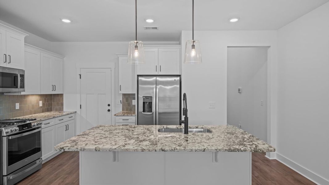 Tasteful kitchen with a streamlined island and modern finishes in a first-class DRB Homes design