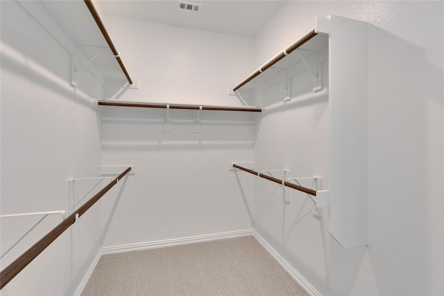 Walk in closet with light colored carpet Walk in closet with light colored carpet