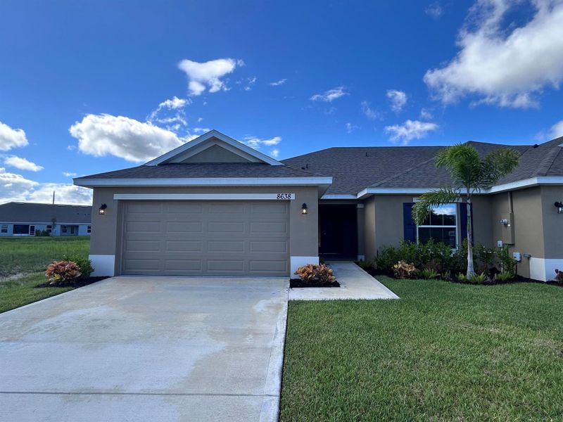 Front exterior of a new home in Waterstone Villas, Fort Pierce, FL, highlighting curb appeal (Image 21). Front exterior of a new home in Waterstone Villas, Fort Pierce, FL, highlighting curb appeal (Image 21).
