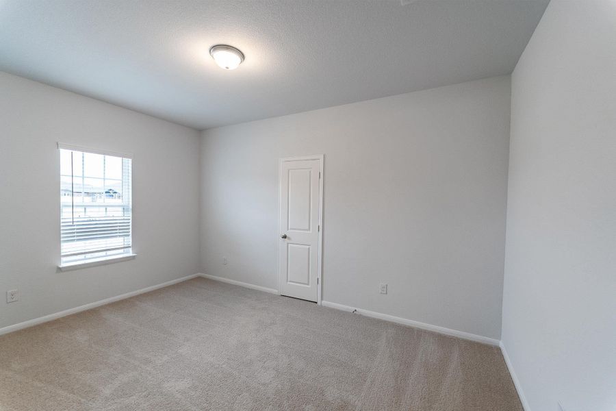 Unfurnished room with light colored carpet and baseboards
