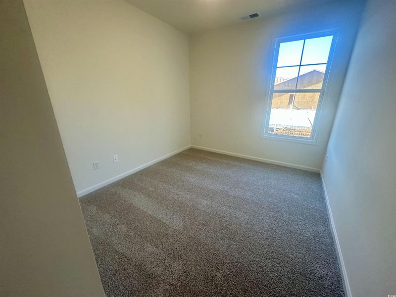 Unfurnished room featuring carpet flooring and baseboards