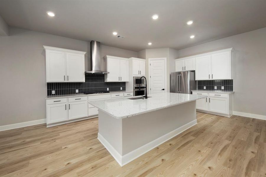 This open kitchen connects to the family room and dining room, allowing you to be close to everything.