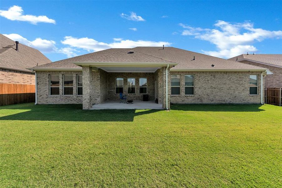 Back of property with a patio area and a lawn