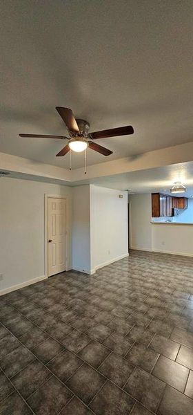 Dining room featuring ceiling fan and a textured ceiling