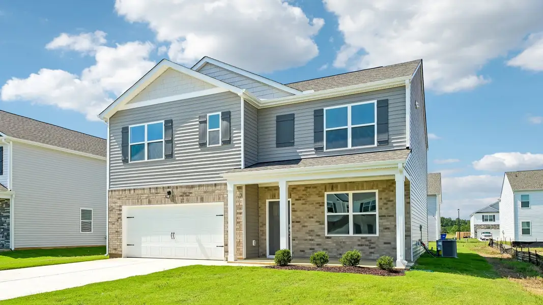 Front exterior of a new home in Shahbain Reserve, Raeford, NC, highlighting curb appeal (Image 2). Front exterior of a new home in Shahbain Reserve, Raeford, NC, highlighting curb appeal (Image 2).
