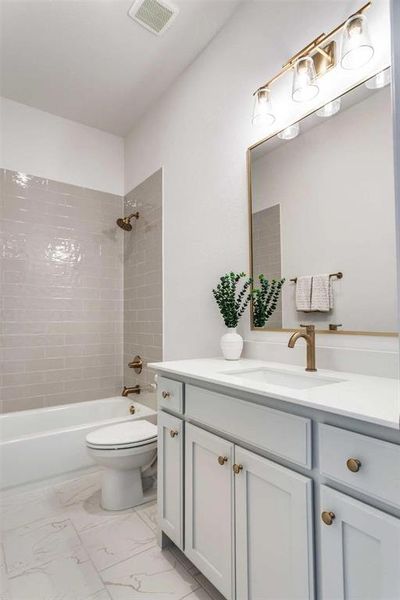 Full bath featuring vanity, shower / bath combination, and light marble finish floors