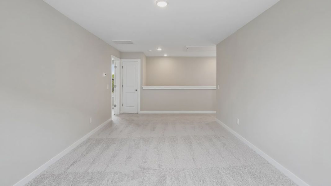 Second Floor Loft area with windows and carpet Second Floor Loft area with windows and carpet