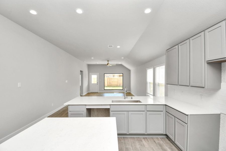 All of this overlooks your expansive family room, creating a perfect space for culinary delights and family gatherings.