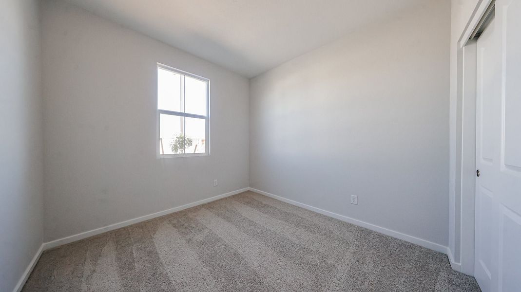A room with a window and carpet. A room with a window and carpet.