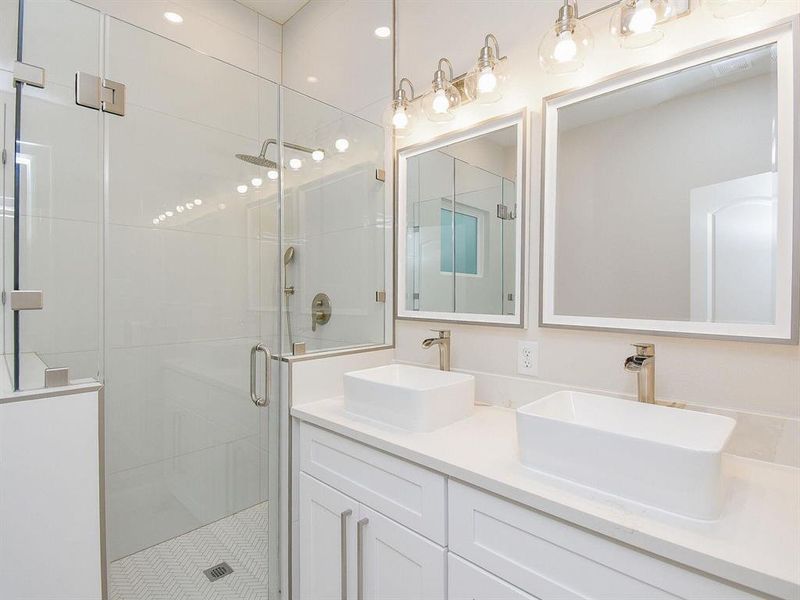 Both the master bedroom and guest bathroom have full-size showers, separate soaking tubs, double vanities, waterfall, and wall shower heads.