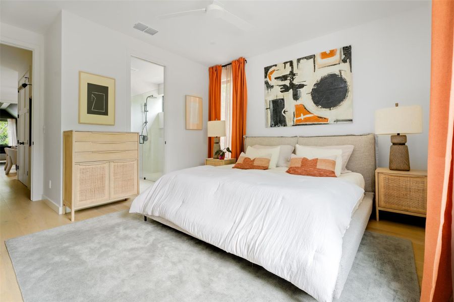 Bedroom featuring ceiling fan, visible vents, and wood finished floors