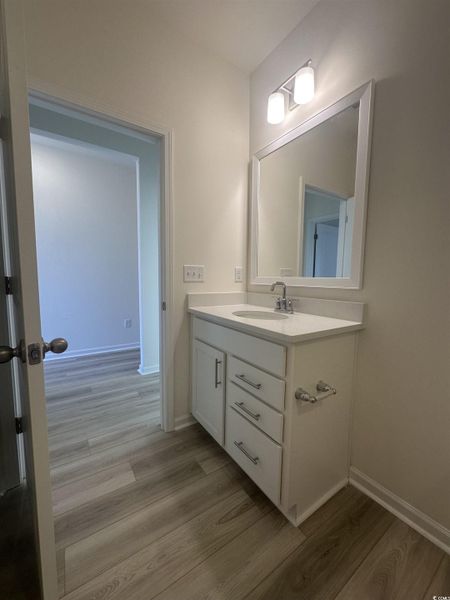 Bathroom with vanity and light wood finished floors