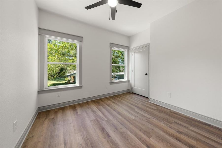 Empty room featuring light wood-style flooring and ceiling fan