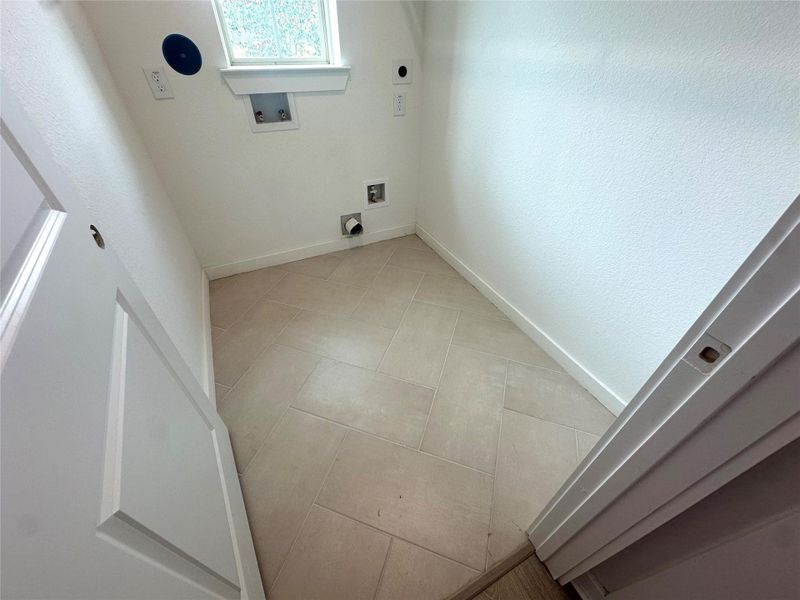 Lux herringbone tile even in utility room.