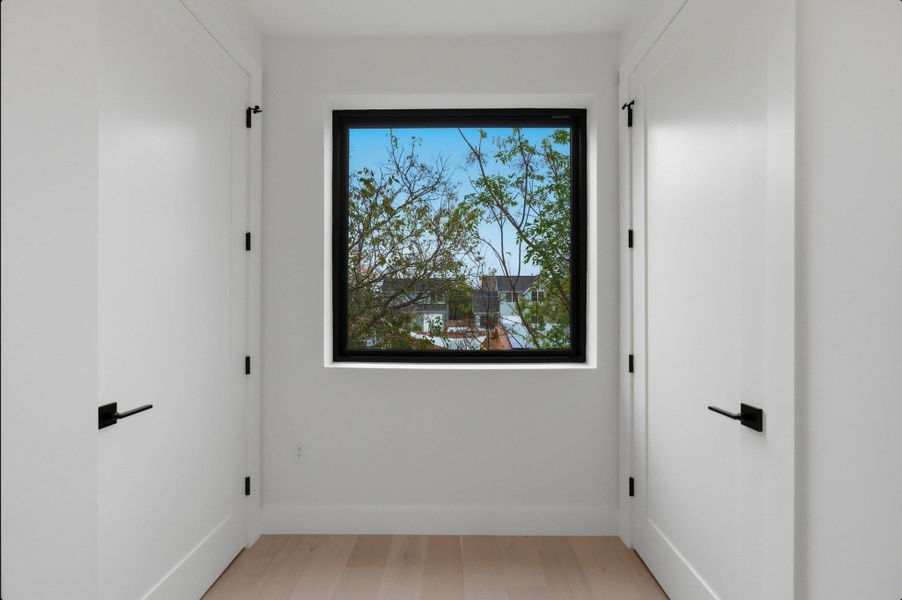 Spare room featuring light wood-type flooring and baseboards Spare room featuring light wood-type flooring and baseboards
