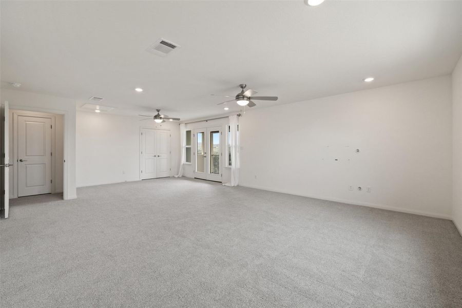 Spare room featuring a ceiling fan, recessed lighting, light colored carpet, and visible vents