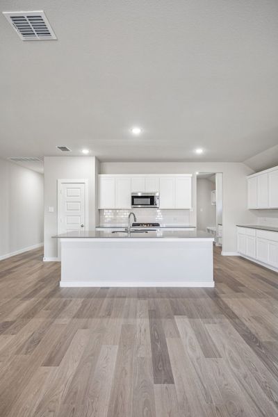 Kitchen in the Heisman home plan by Trophy Signature Homes – REPRESENTATIVE PHOTO