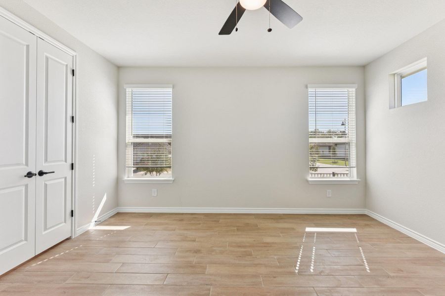 Unfurnished bedroom with a closet, ceiling fan, and light wood finished floors
