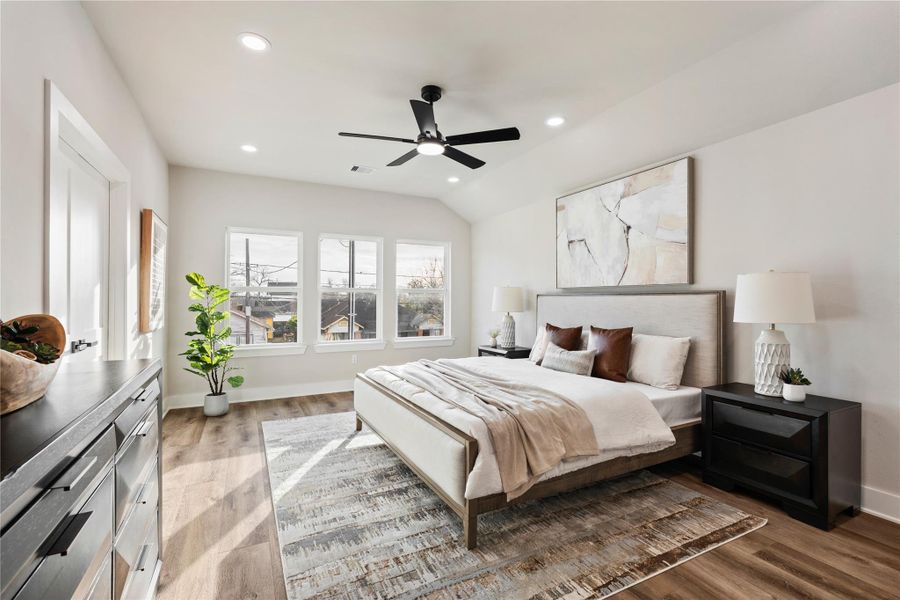 The primary bedroom is a peaceful retreat with high ceilings and large windows that bring in beautiful natural light. With generous space and a calming, airy feel, it’s the perfect place to unwind and recharge.