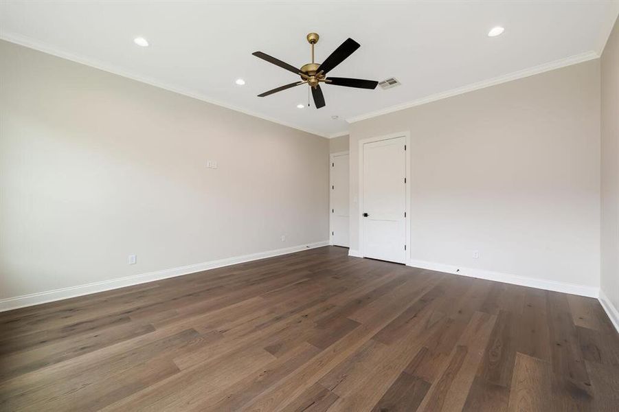 Spare room featuring dark wood-type flooring, a ceiling fan, recessed lighting, and crown molding Spare room featuring dark wood-type flooring, a ceiling fan, recessed lighting, and crown molding