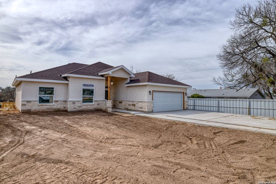 Front exterior of a new home in , Uvalde, TX, highlighting curb appeal (Image 22).