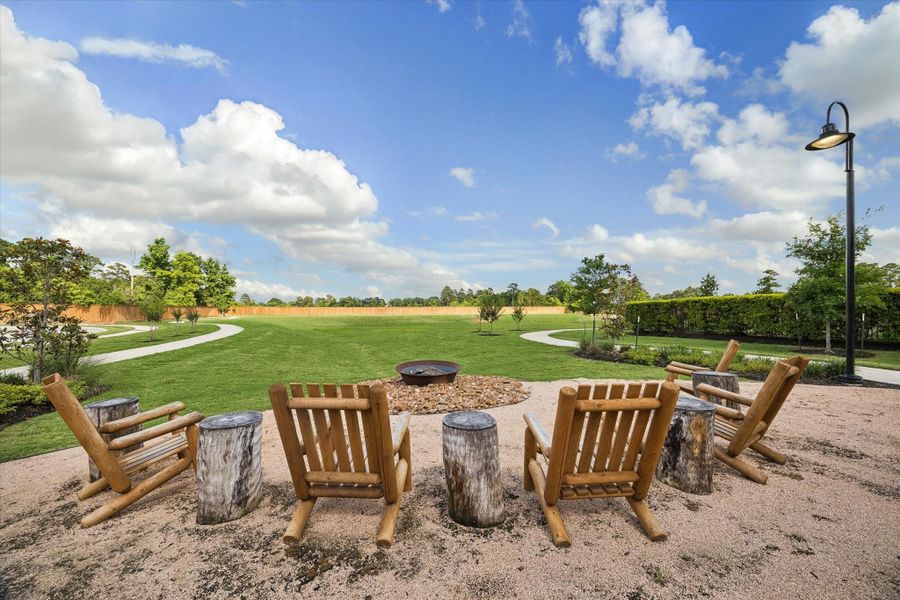 Cozy community firepit area surrounded by rustic Adirondack seating creates the perfect setting for relaxing evenings, neighborhood gatherings, and enjoying the peaceful outdoor atmosphere. Cozy community firepit area surrounded by rustic Adirondack seating creates the perfect setting for relaxing evenings, neighborhood gatherings, and enjoying the peaceful outdoor atmosphere.