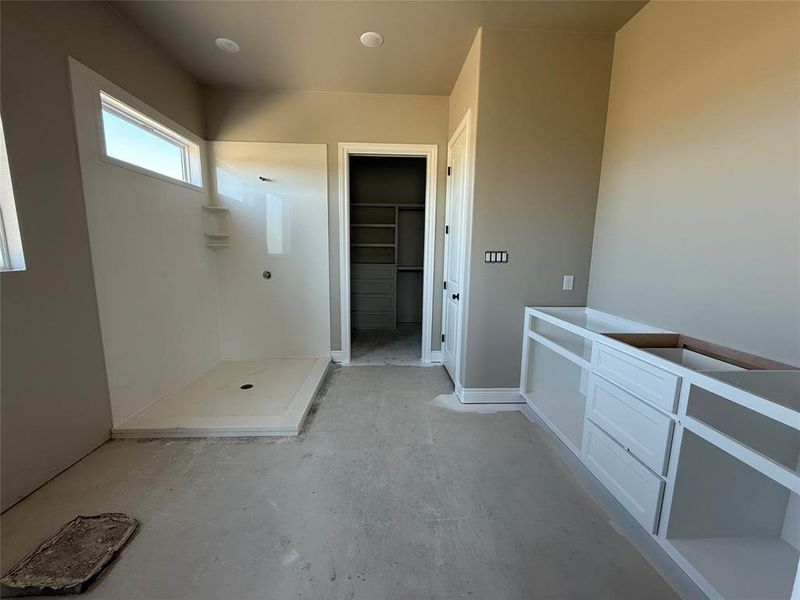 Bathroom featuring a walk in closet and walk in shower