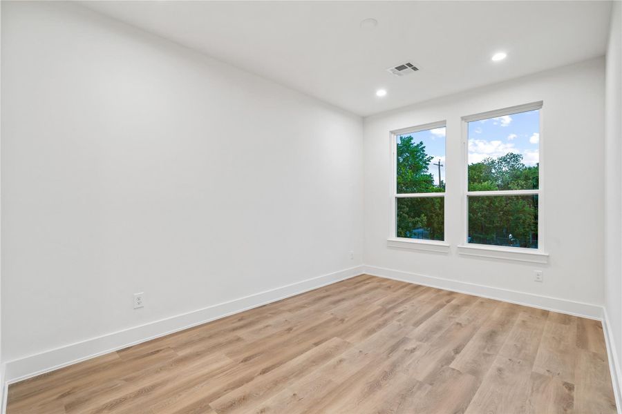 Well-appointed secondary bedrooms with high ceilings, large windows, and walk-in closets. Well-appointed secondary bedrooms with high ceilings, large windows, and walk-in closets.