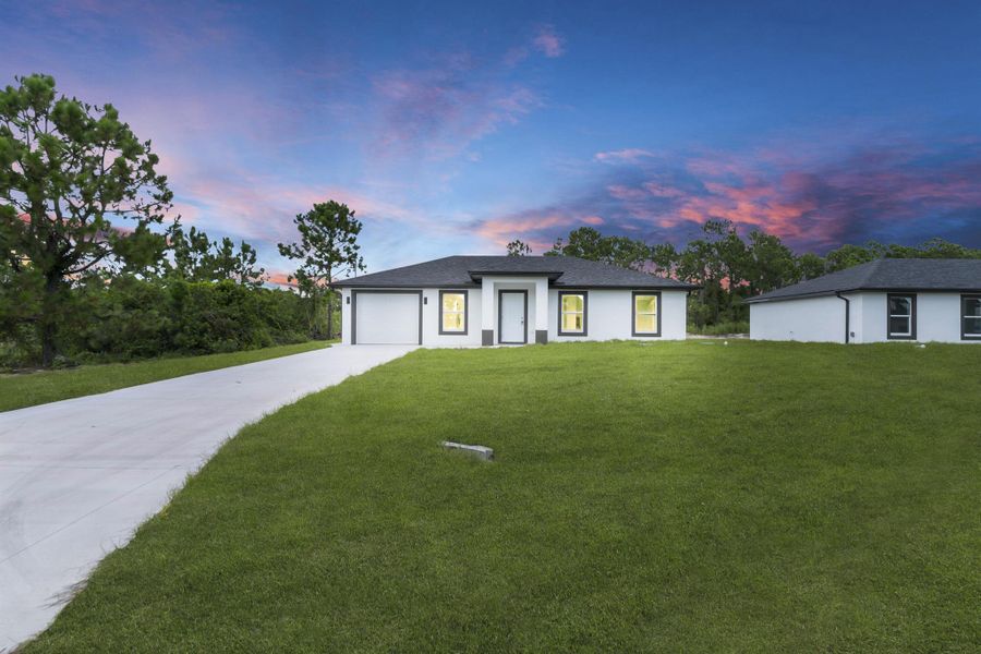 Front exterior of a new home in , Lehigh Acres, FL, highlighting curb appeal (Image 19).