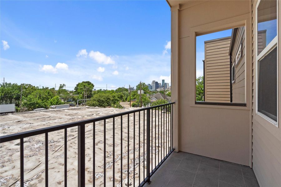 Private balcony from primary bedroom offering fresh air, neighborhood views, and a glimpse of the Downtown Houston skyline. Private balcony from primary bedroom offering fresh air, neighborhood views, and a glimpse of the Downtown Houston skyline.
