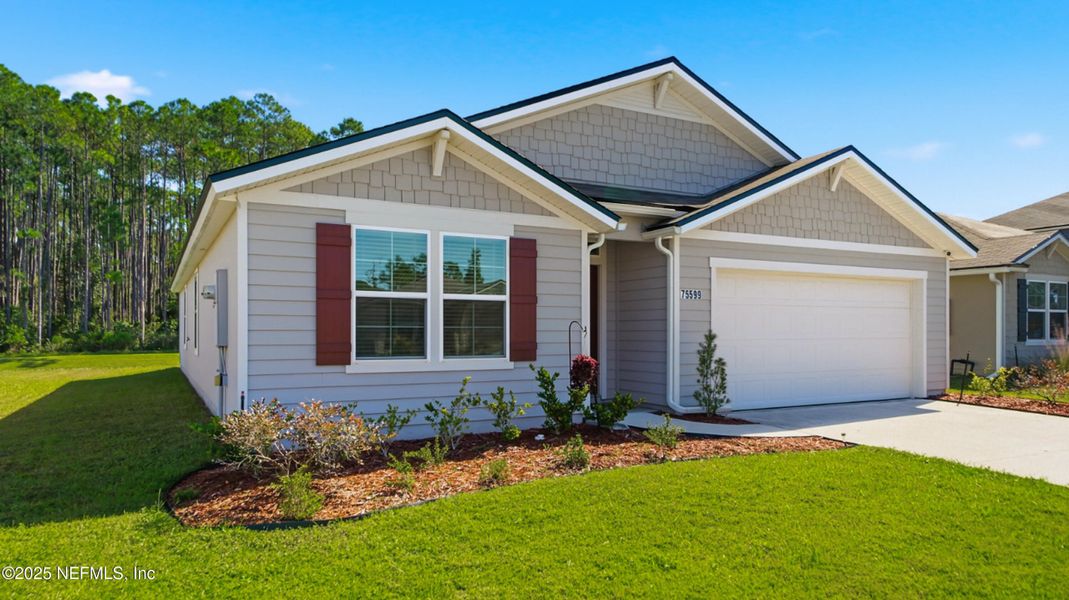 Front exterior of a new home in River Glen Express, Yulee, FL, highlighting curb appeal (Image 23).