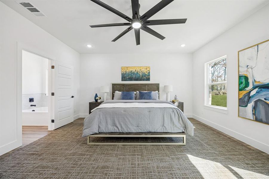 Another view of the primary bedroom showing the ensuite bathroom