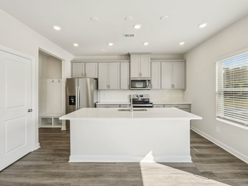 Create a sleek dining space with the modern, oversized kitchen island.
