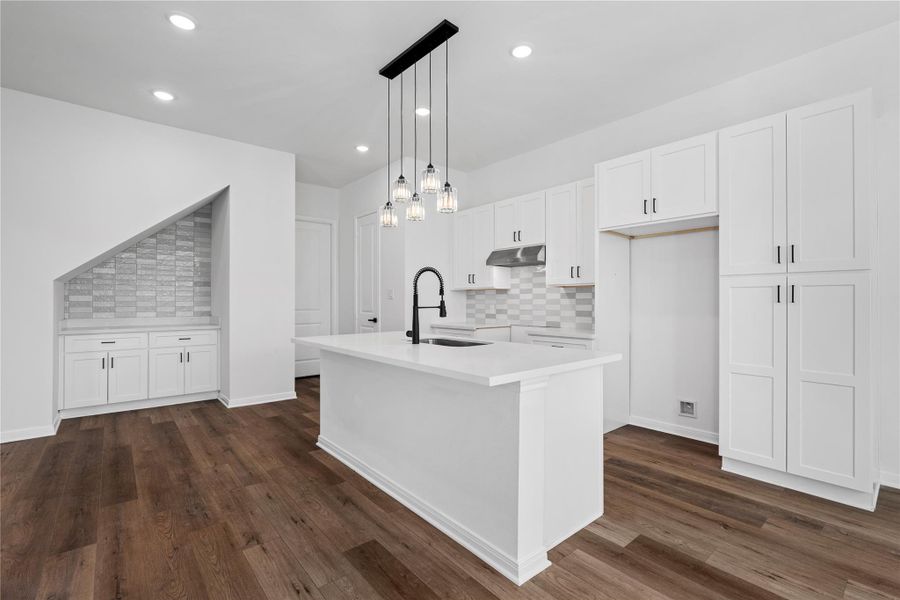 Convenient dry bar area perfect for coffee, cocktails, or extra storage, adding versatility to the kitchen layout.