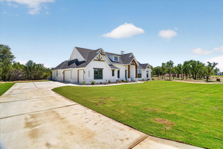 Front exterior of a new home in Timberview Preserves, Weatherford, TX, highlighting curb appeal (Image 24).