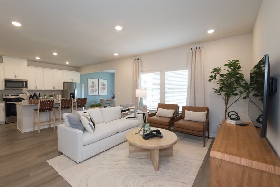 The kitchen overlooks into the living room and dining room in this homes open-concept floorplan.