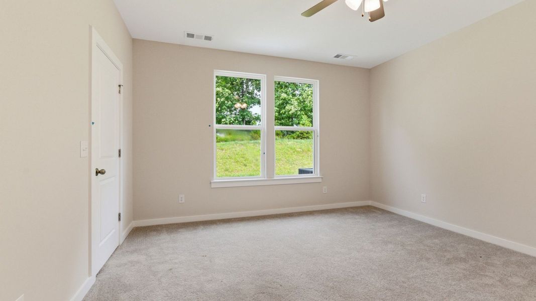 Bedroom with carpet and ceiling fan Bedroom with carpet and ceiling fan