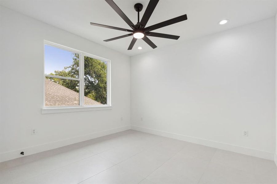 Unfurnished room featuring ceiling fan and light tile patterned floors