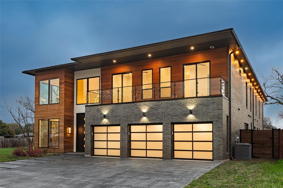 Contemporary home featuring a balcony, a garage, and central AC