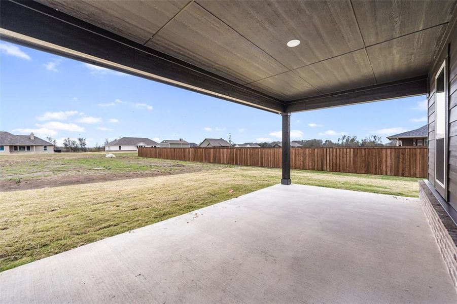 Fenced backyard with a patio area and a residential view