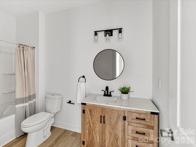 Full bathroom featuring a stylish vanity with ample storage, modern fixtures, and a tub/shower combination for everyday convenience. Full bathroom featuring a stylish vanity with ample storage, modern fixtures, and a tub/shower combination for everyday convenience.