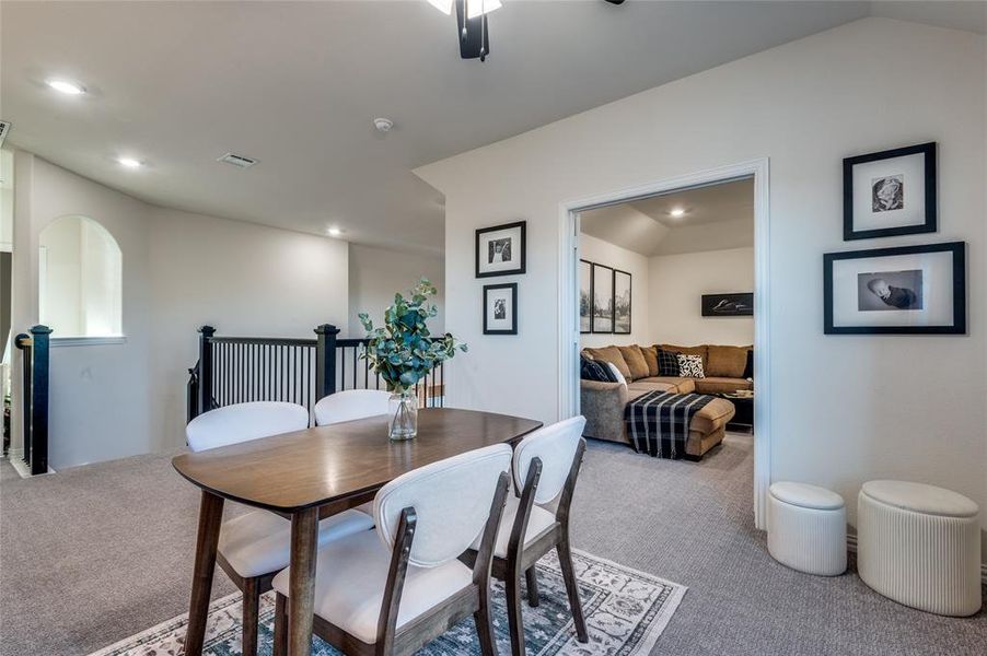 Dining room featuring carpet, lofted ceiling, and ceiling fan