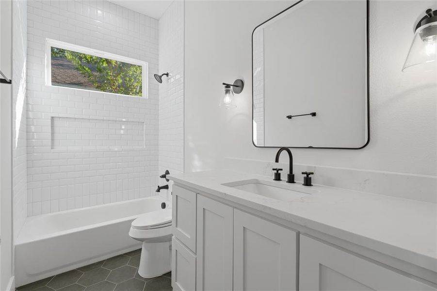 Bathroom featuring a white subway-tiled shower with a built-in niche and a horizontal window Bathroom featuring a white subway-tiled shower with a built-in niche and a horizontal window