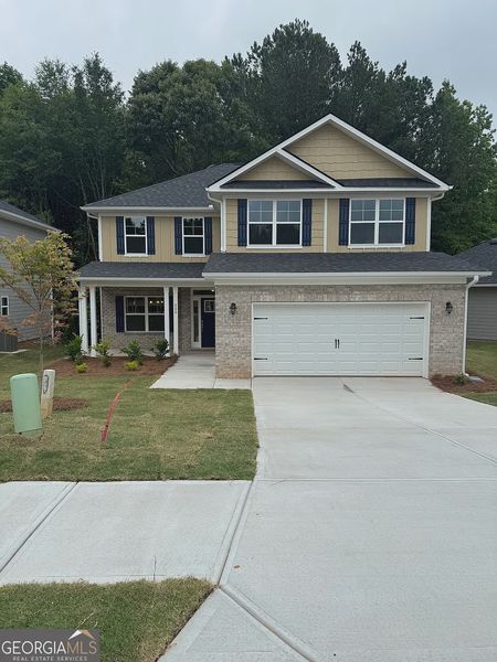 Front exterior of a new home in Canterbury Villas, Carrollton, GA, highlighting curb appeal (Image 1).