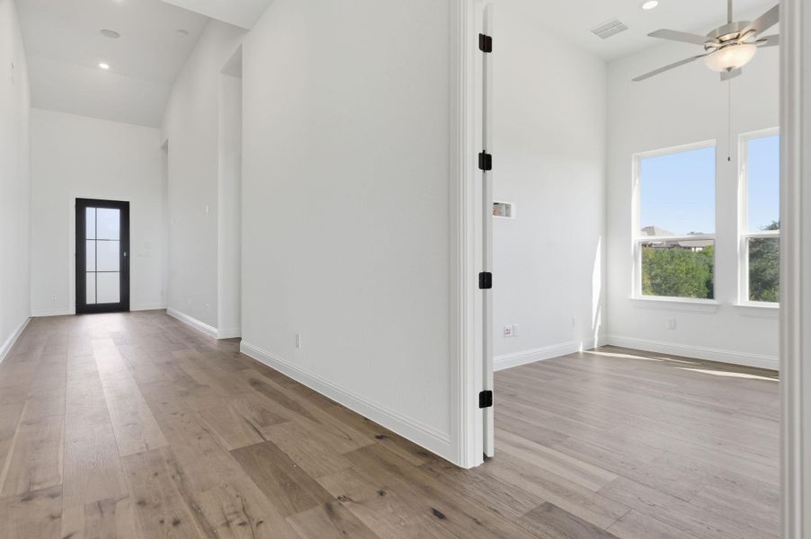 Foyer entrance with recessed lighting, light wood-style floors, a towering ceiling, and a ceiling fan