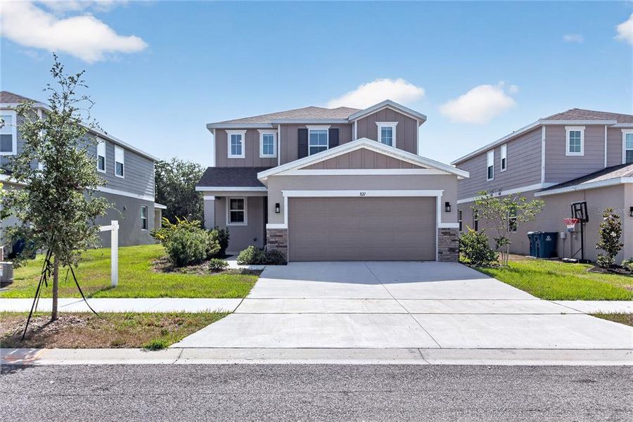Front exterior of a new home in Seasons at Forest Creek, Haines City, FL, highlighting curb appeal (Image 32).