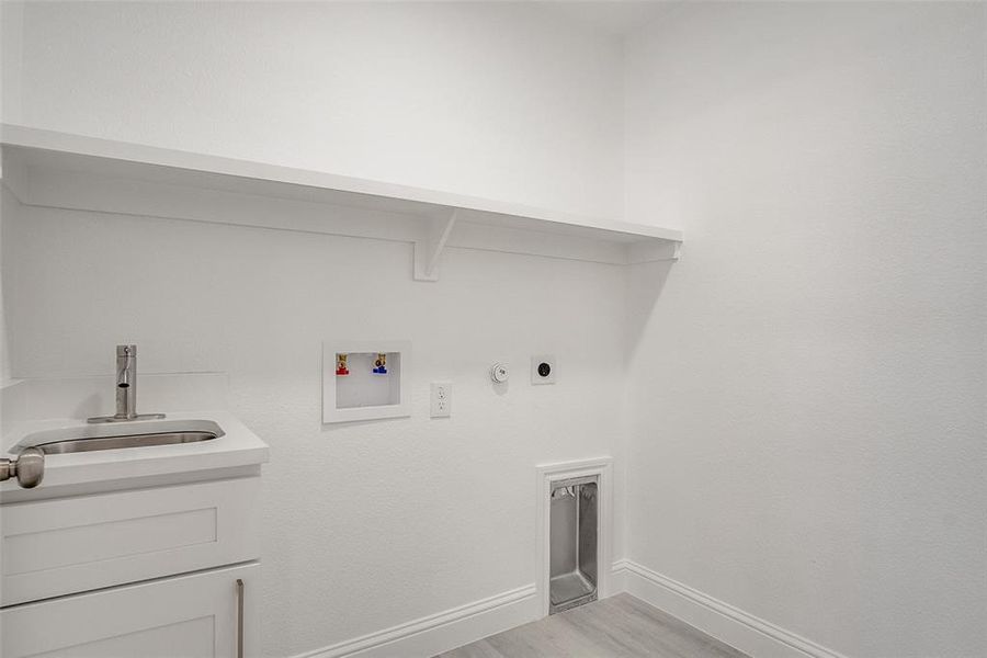 Laundry area featuring hookup for a gas dryer, light wood-style floors, and hookup for a washing machine Laundry area featuring hookup for a gas dryer, light wood-style floors, and hookup for a washing machine